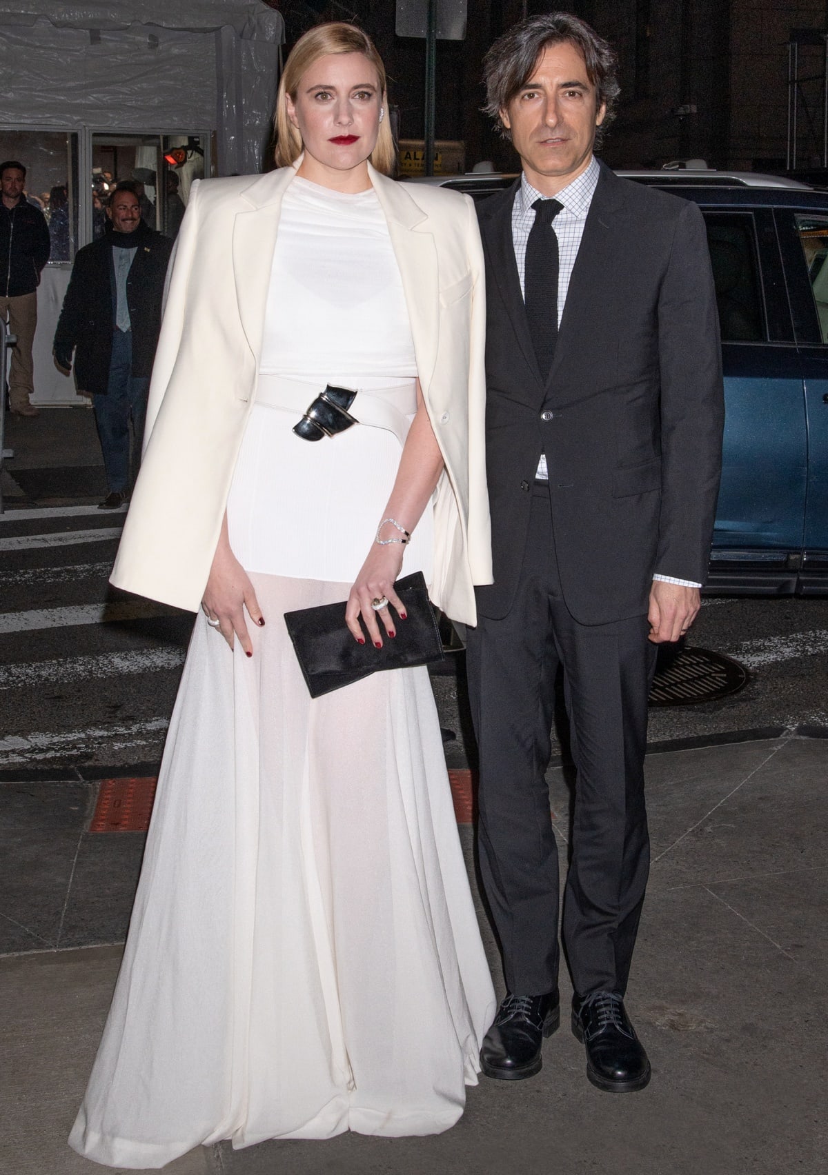 Greta Gerwig, chic in a floor-sweeping Brandon Maxwell gown with hidden heels, posed alongside her partner Noah Baumbach—her co-writer on Barbie—at the 2023 Gotham Awards