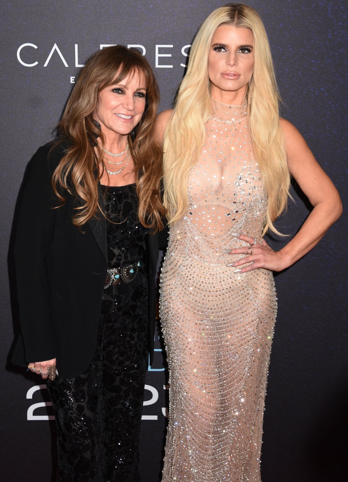 Jessica Simpson with mom Tina Simpson in an all-black sequin jumpsuit with a statement belt and a chic blazer