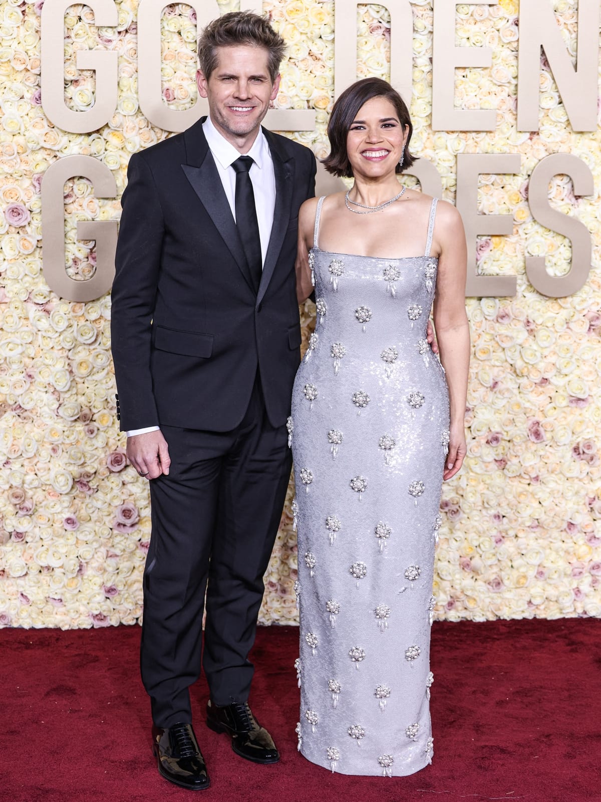 At the 81st Golden Globe Awards in Beverly Hills, America Ferrera, accompanied by her husband Ryan Piers Williams, radiates glamour in a form-fitting silver gown from Dolce Gabbana