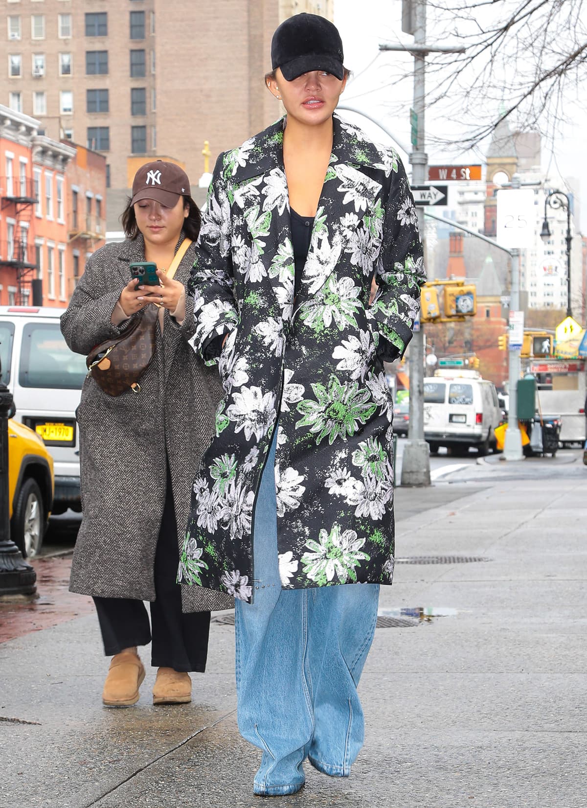 Chrissy Teigen enjoys her Chrissy Dave Dine Out press tour break in a black cropped sweater, baggy jeans, and a floral Stine Goya coat in New York City