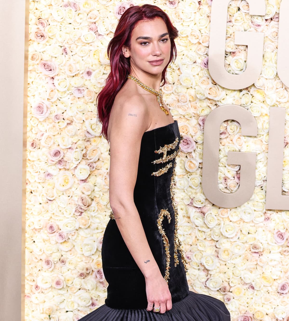 Styled by Lorenzo Posocco, Dua Lipa embodied sophistication in her Schiaparelli gown, Tiffany Co. jewelry, and a matching velvet minaudière clutch