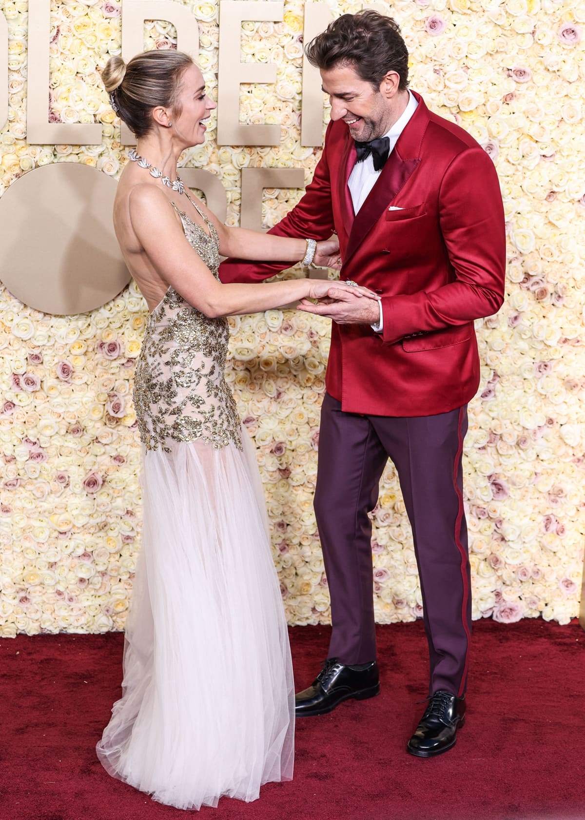 At the 2024 Golden Globes, Emily Blunt glowed in a gold Alexander McQueen gown alongside John Krasinski, who complemented her in a sharp Dolce Gabbana red suit