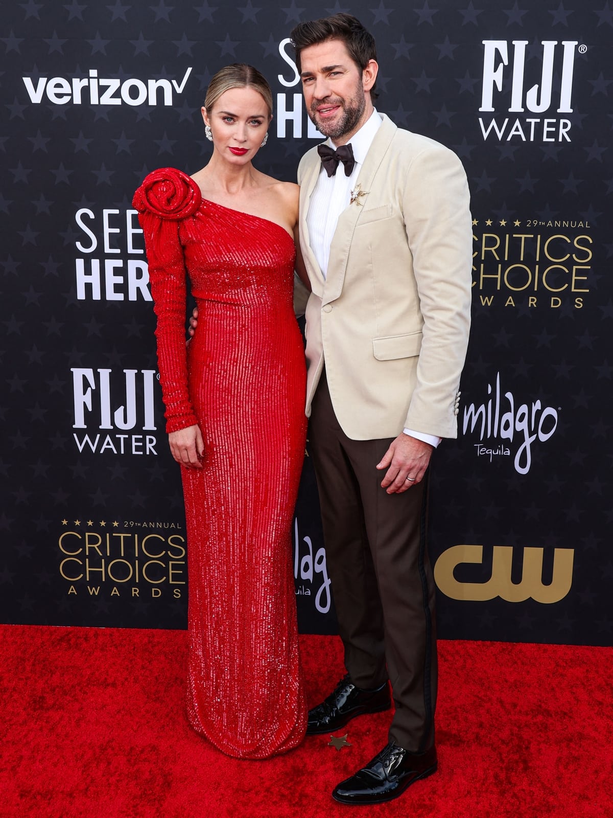 Emily Blunt and John Krasinski radiate Hollywood glamour at the 29th Annual Critics Choice Awards in Santa Monica, with Emily in a stunning Armani Privè gown and John in a sleek off-white suit jacket