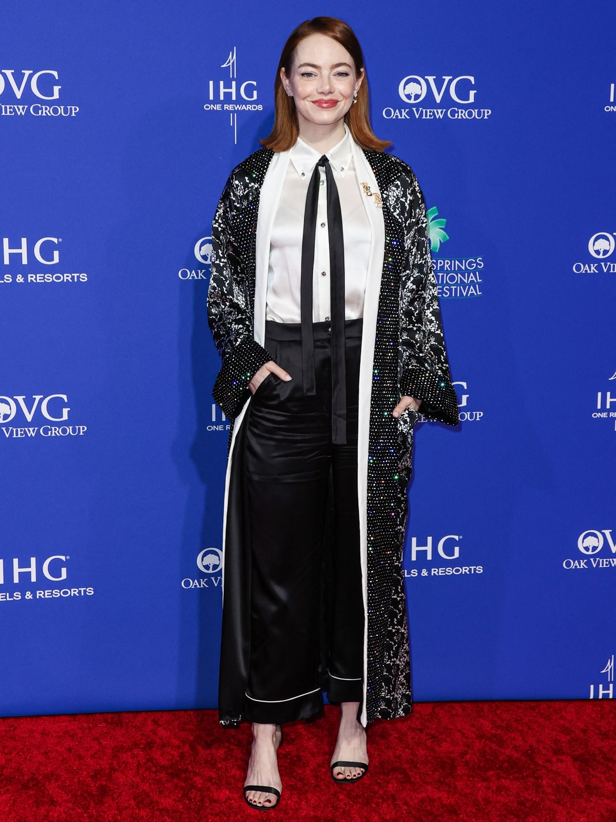 Emma Stone lights up the 35th Palm Springs International Film Festival in a custom black-and-white Louis Vuitton ensemble finished with sleek strappy sandals as she accepts the Desert Palm Achievement Award