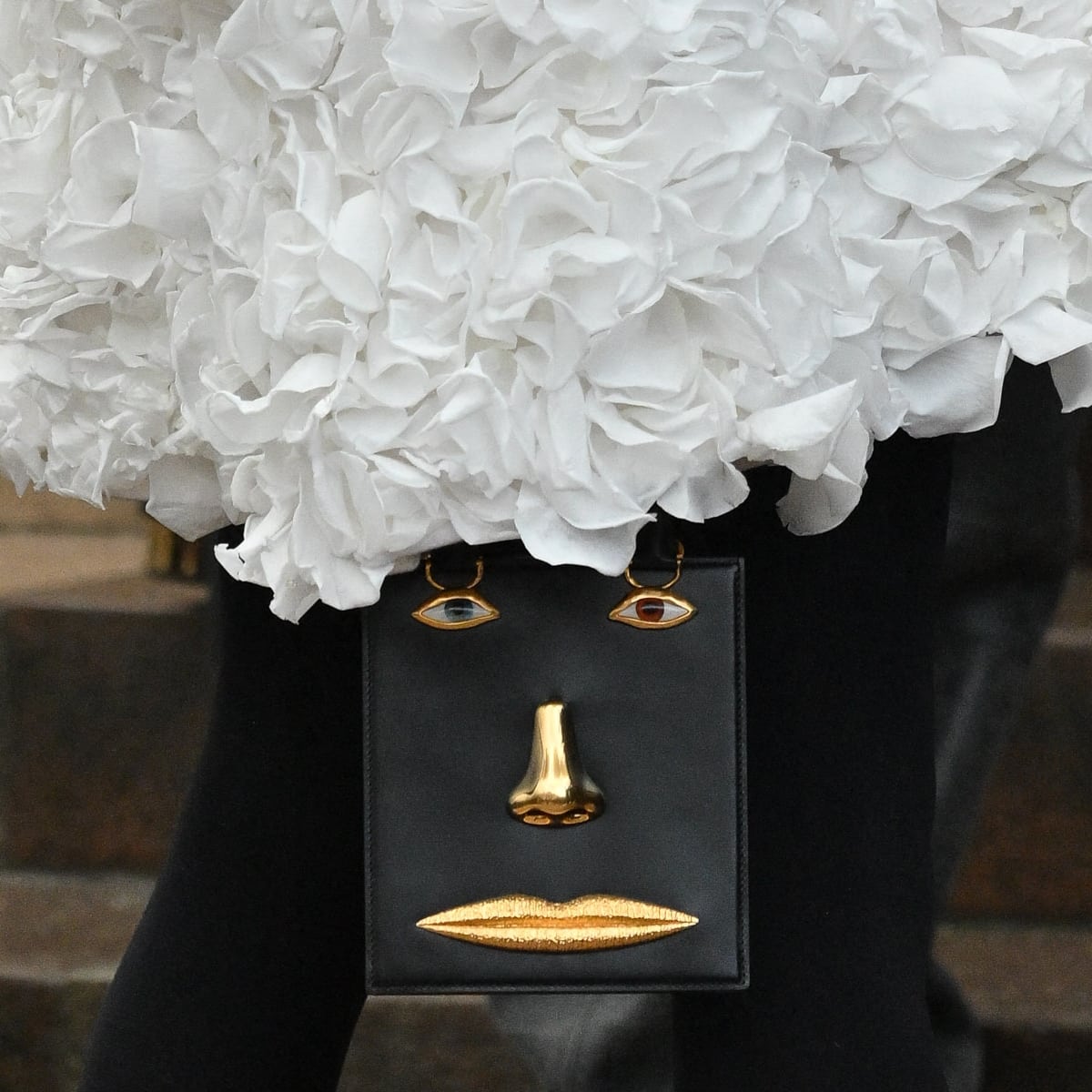 Crafted in luxurious black calfskin, this Jennifer Lopez's double-gusset bag bag features a central zip pocket accentuated by unique anatomical gilded brass adornments