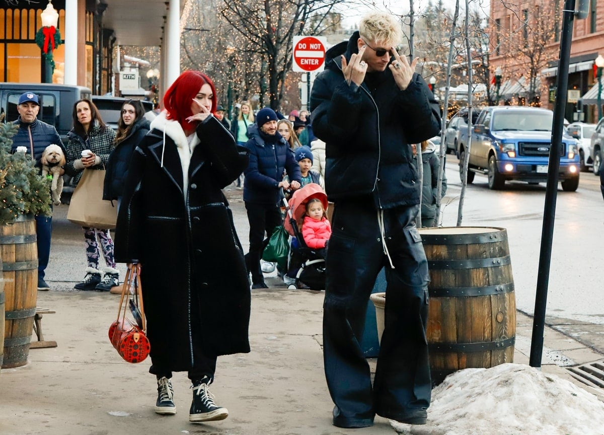 Chic in the chill, Megan Fox pairs her black-and-white winter layers with Rick Owens DRKSHDW “Ramones” sneakers, adding a casual edge to her statement red hair and patterned purse
