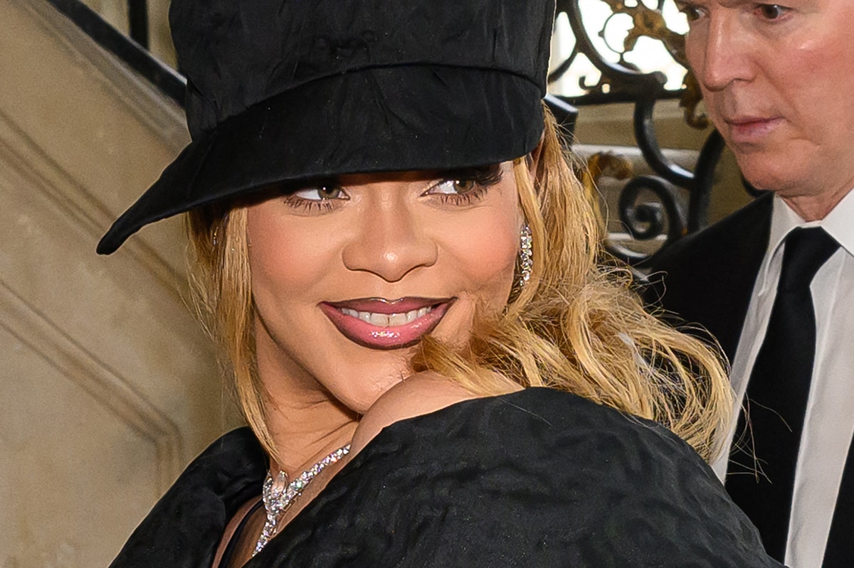Rihanna lets her wavy hair flow past her shoulders and wears overline ombre lips for added drama