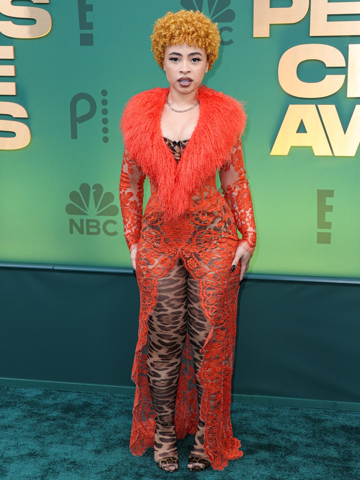 Ice Spice captivates at the 2024 People's Choice Awards in a bespoke Dolce Gabbana sheer orange coatdress