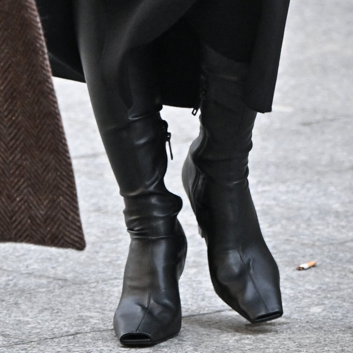 Emily Ratajkowski steps out in style with chunky black leather boots, perfectly complementing her bold and edgy outfit with a touch of urban sophistication
