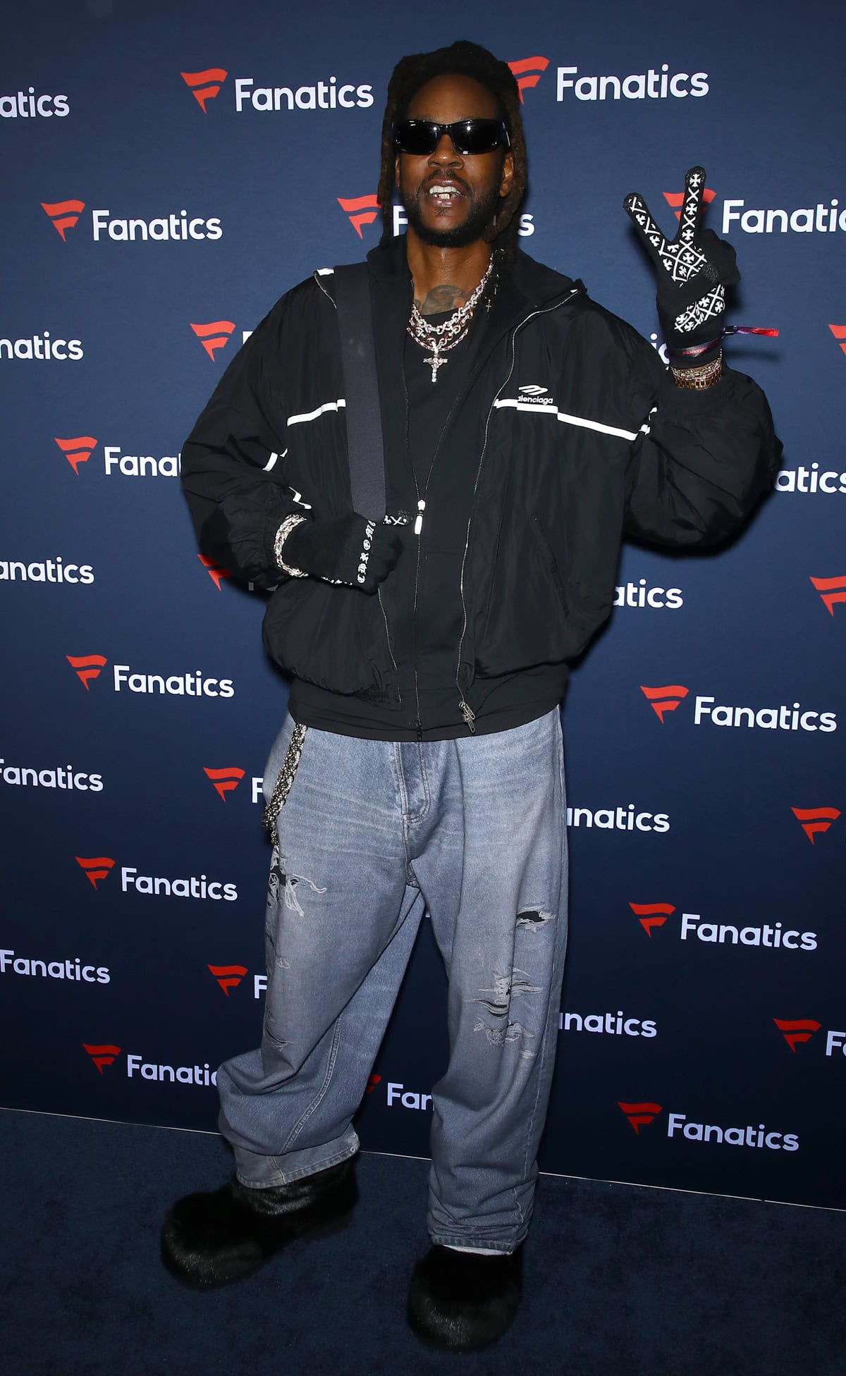 2 Chainz keeps it cozy and bold in oversized denim and furry black footwear at the Fanatics Super Bowl Party