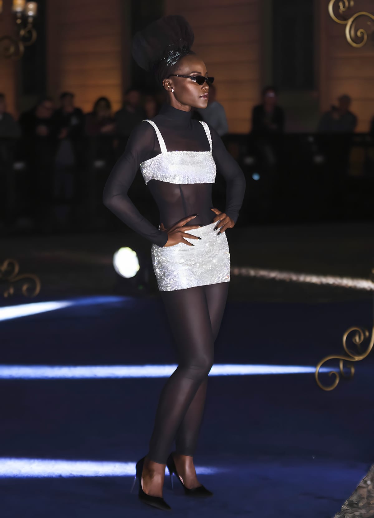 Lupita Nyong'o exudes confidence in her see-through black bodysuit and crystal co-ord paired with Dolce Gabbana satin pumps