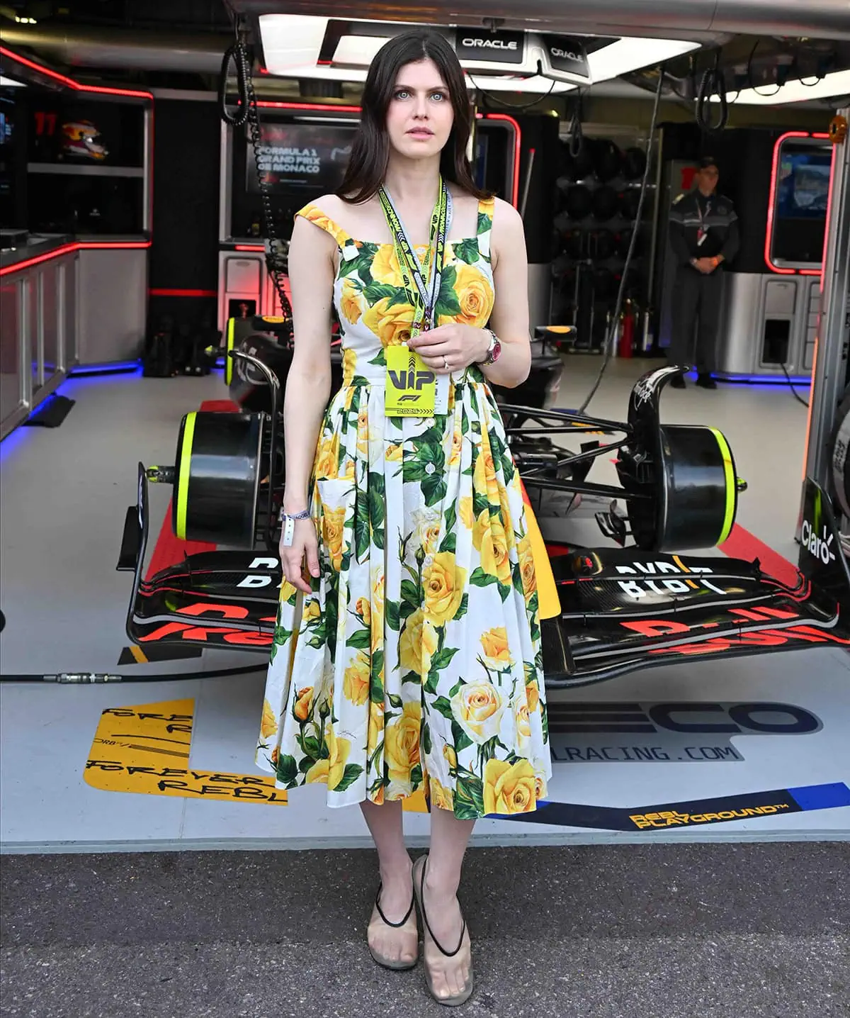 Alexandra Daddario's Dolce Gabbana floral dress features front buttons and a pleated midi skirt, making it a perfect summertime dress