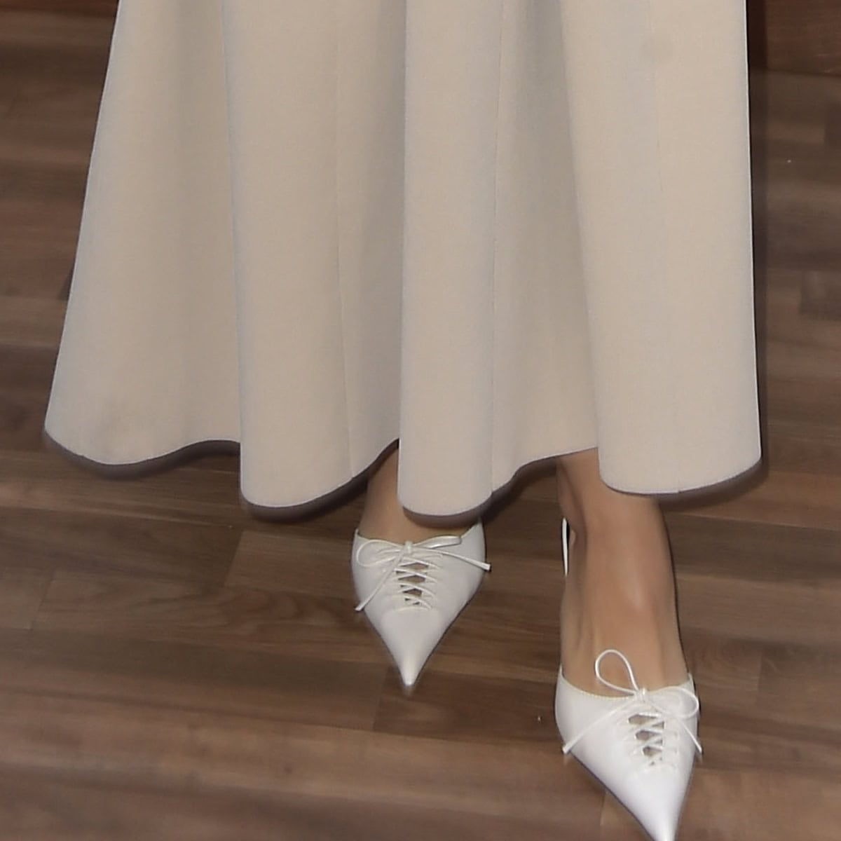 A perfect blend of simplicity and sophistication: Camila Mendes pairs her elegant beige dress with white Femme Louis slippers