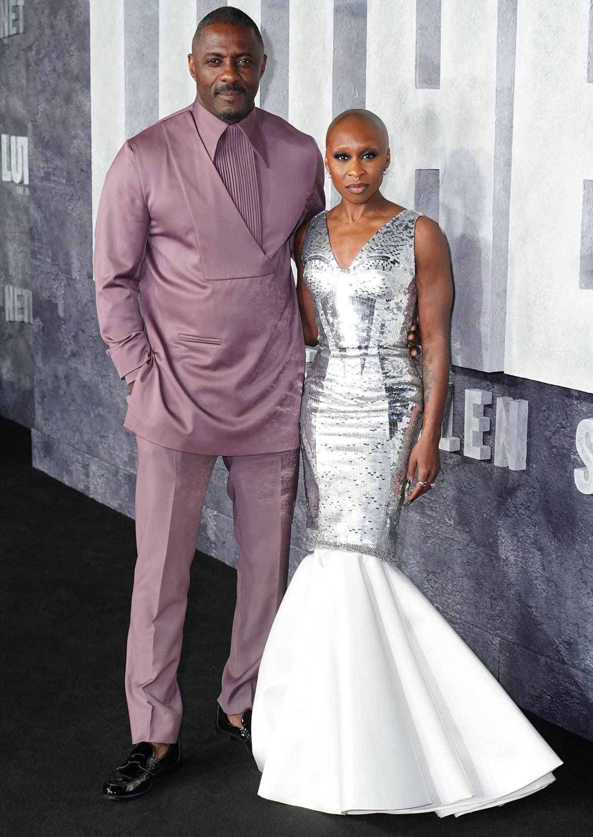 Despite likely wearing heels hidden beneath her dramatic fishtail gown, Cynthia Erivo appears noticeably petite next to the towering Idris Elba on the red carpet