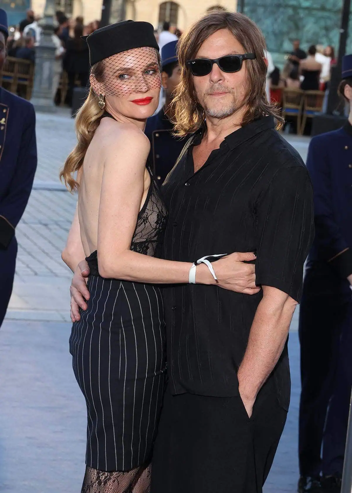 Diane Kruger completes the look's vintage grandeur with a shiny, soft wavy hairstyle, rosy blush, and vibrant red lipstick