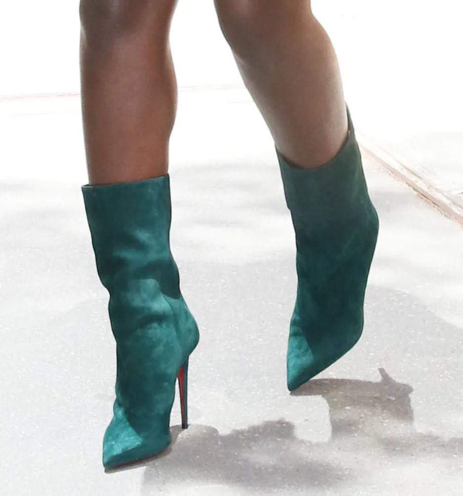 Jodie Turner-Smith completes her vintage ensemble with the Christian Louboutin Astrilarge boots in Vosges Green suede