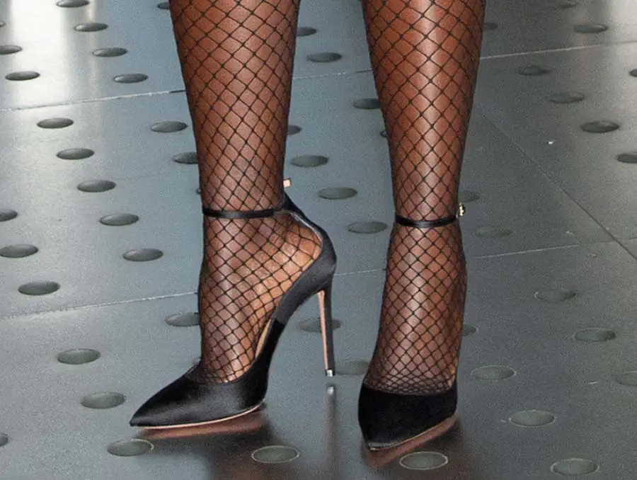 Lupita Nyong'o teams her daring playsuit with fishnets and black satin Aquazzura Love Affair pumps