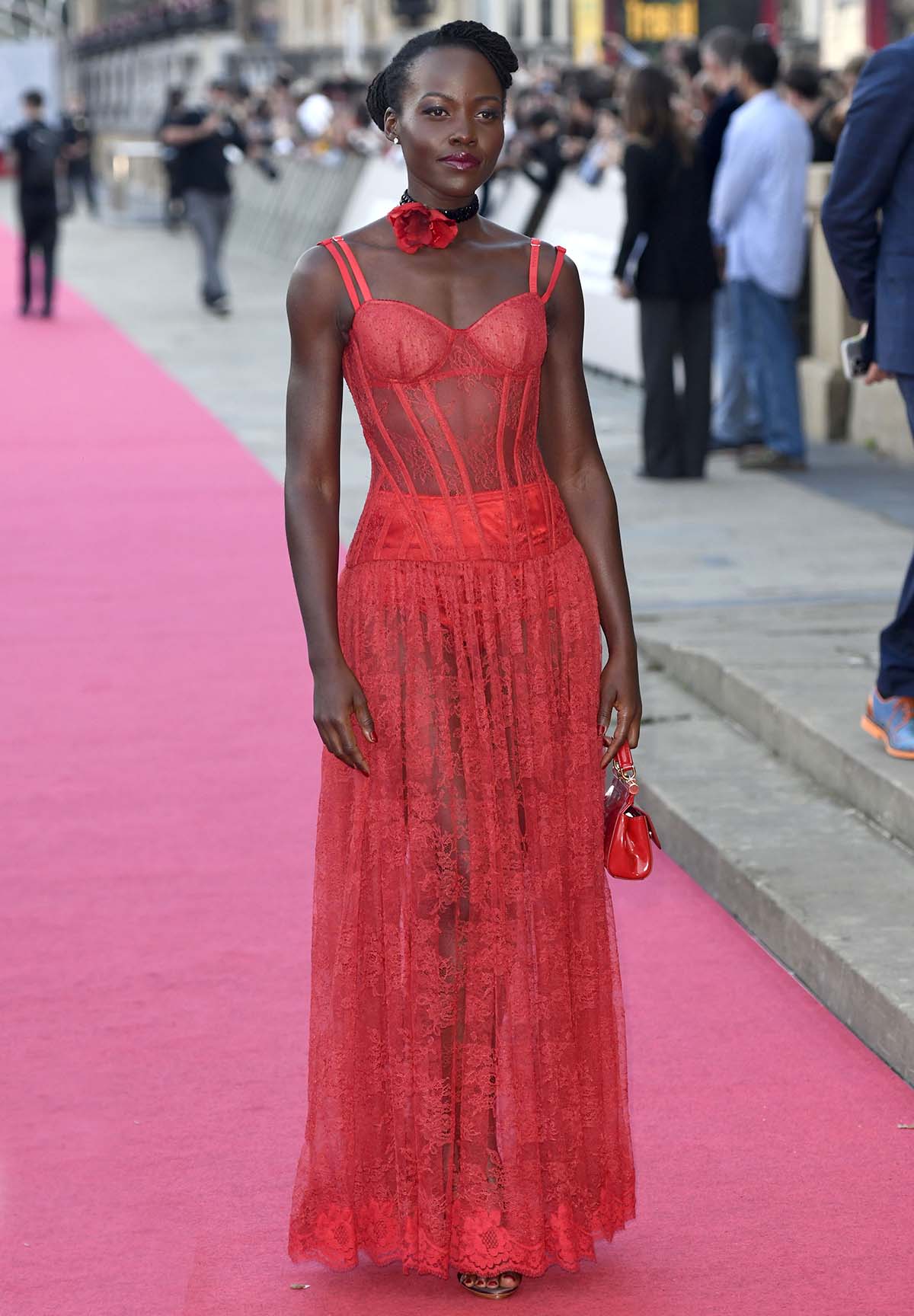 Lupita Nyong'o is bold yet sophisticated in a red see-through lace corset dress by Dolce Gabbana at The Wild Robot premiere
