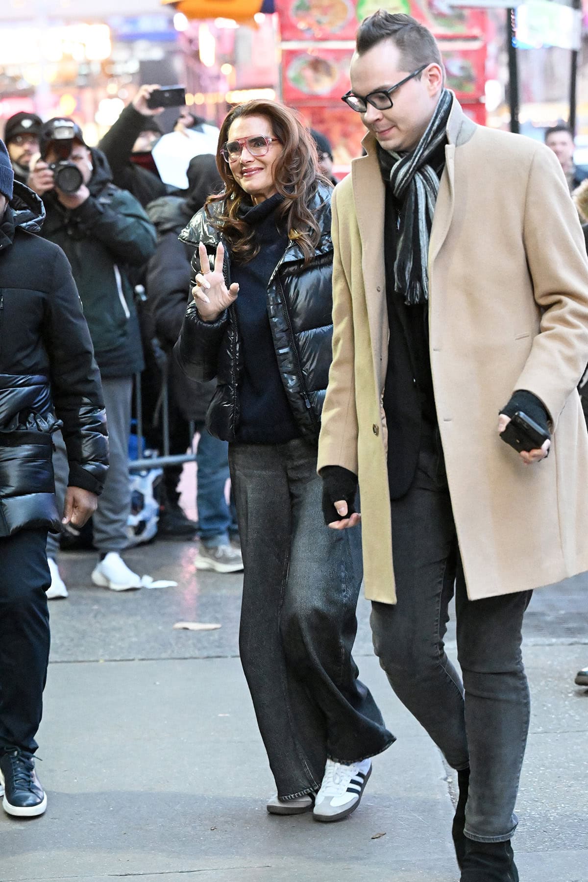 Before slipping into metallic pumps and Thom Browne tailoring, Brooke Shields arrived in classic white-and-black Adidas Samba sneakers paired with relaxed denim and a black puffer jacket