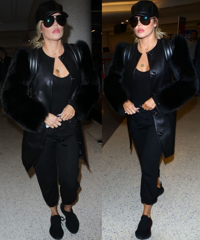 Khloé Kardashian kept her LAX airport look sleek and streetwise on March 31, 2017, grounding a supple leather coat and ribbed bodysuit with Adidas x Kanye West Yeezy Boost 350 “Pirate Black” sneakers for an effortlessly cool travel outfit