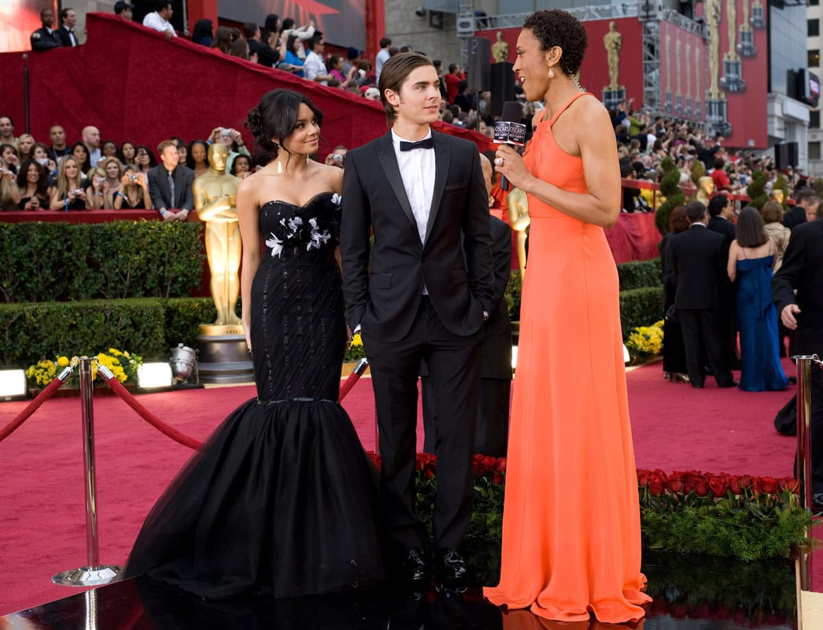 Vanessa Hudgens brought Old Hollywood glamour to the 2009 Oscars in a floral-embellished black Marchesa fishtail gown, pairing the dramatic silhouette with elegant heels that complemented Zac Efron's classic Dolce Gabbana tuxedo and polished Bally shoes on February 22, 2009