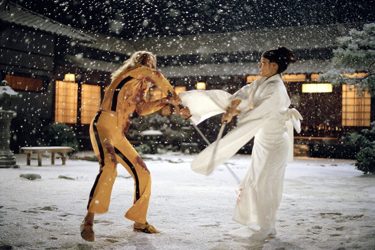 In an iconic snowy showdown from Kill Bill: Volume 1, Lucy Liu’s O-Ren Ishii slices in an all-white kimono and traditional tabi shoes, while Uma Thurman’s The Bride strikes in her blood-streaked yellow tracksuit and Onitsuka Tiger sneakers