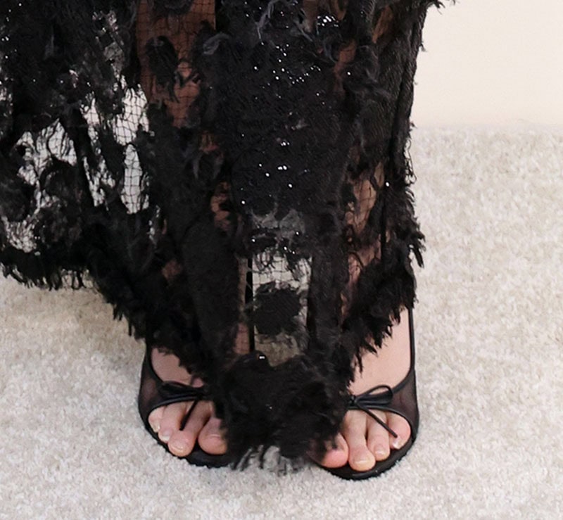Cara Delevingne takes the dark glamour route in Cult Gaia Cici pumps crafted from breathable mesh with ribbons on the toe and slingback straps