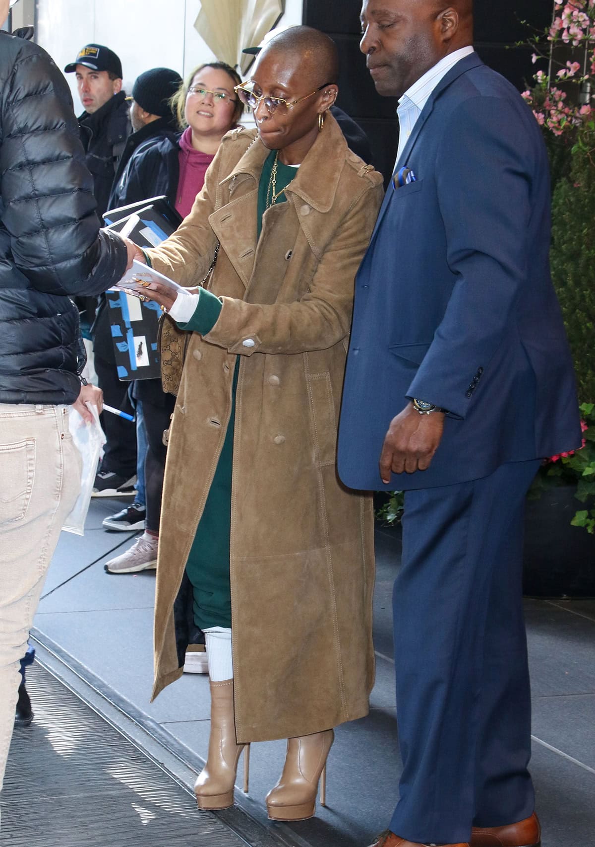 Cynthia Erivo greets her fans outside the Mandarin Oriental Hotel in New York City wearing a green ensemble that mixes streetwear and elegance