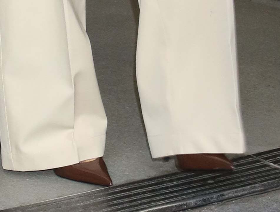 Eva Longoria embraces business chic in a pair of brown patent leather pumps with pointed toes and stiletto heels