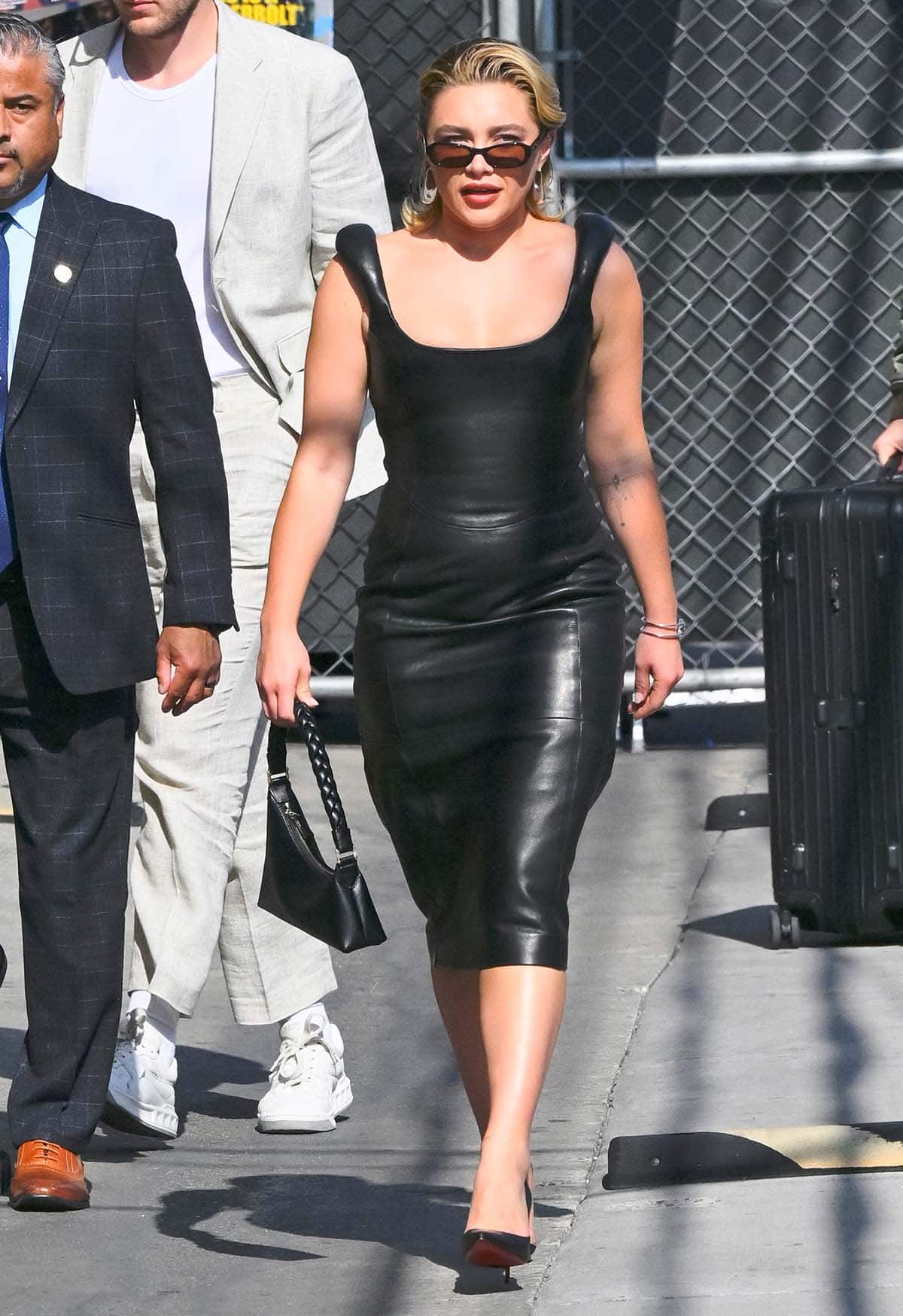 Florence Pugh visits Jimmy Kimmel Live! in a form-fitting black leather sleeveless dress with puffed shoulder straps by Marine Serre