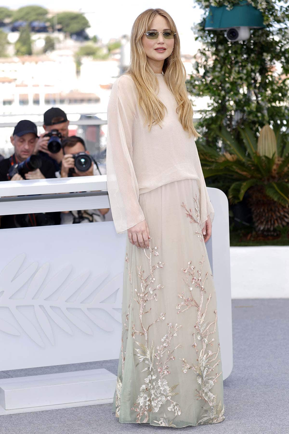 Jennifer Lawrence looks chic and fresh in a beige organza top and green ombre maxi skirt with botanical embroideries at the photocall for Die, My Love during the 2025 Cannes Film Festival