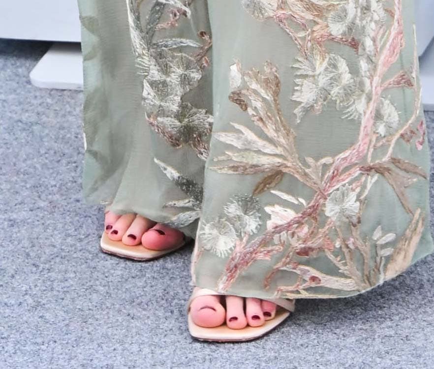 Jennifer Lawrence completes her boho ensemble with simple nude open-toe sandals by Christian Louboutin