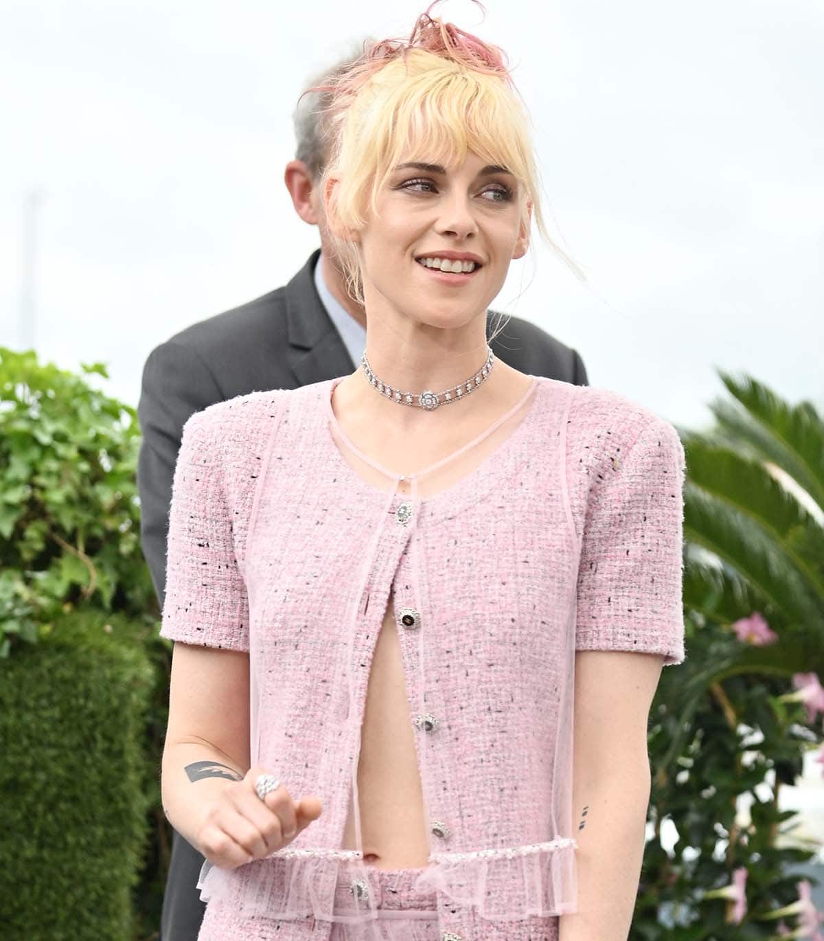 Kristen Stewart styles her pink look with a Chanel diamond choker and her freshly bleached hair with pink dip dye