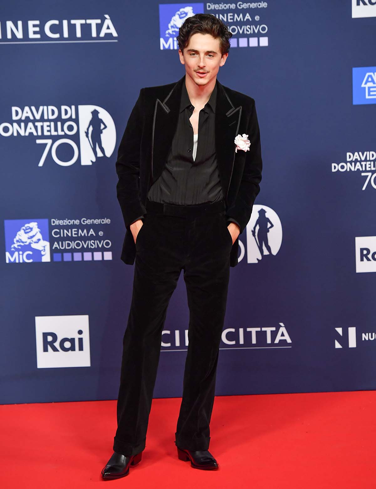 Timothée Chalamet looks handsome in a black velvet Tom Ford suit with a black Oxford shirt and black dress shoes