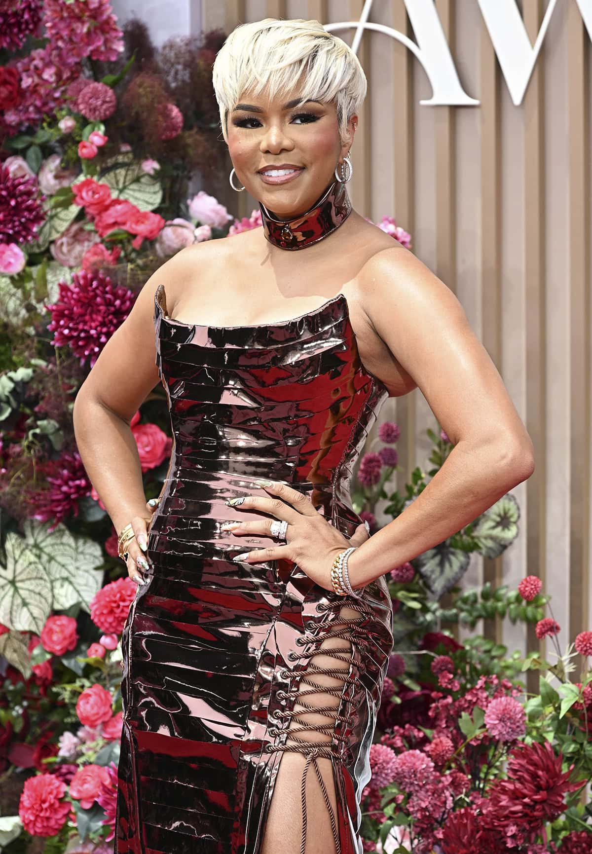 LeToya Luckett shimmers in a bronze Ken White dress featuring a liquid metal effect and corset ties at the back and sides of the skirt