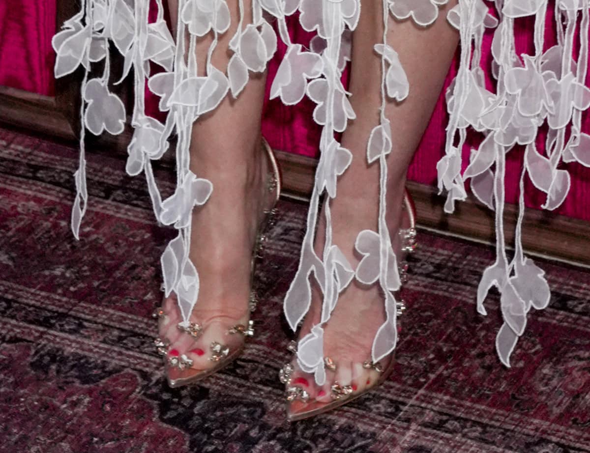 Leighton Meester pairs her elaborate dress with the Christian Louboutin Degraqueen pumps in clear PVC with clusters of crystal embellishments