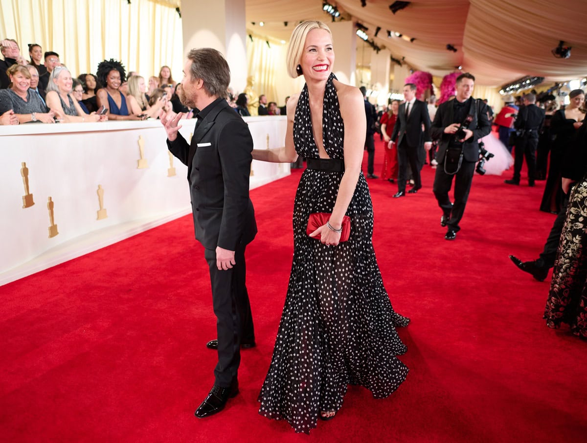 Leslie Bibb stuns in a plunging black-and-white polka-dot Dolce Gabbana gown alongside Sam Rockwell in a sharp Dolce Gabbana tuxedo on the 96th Oscars red carpet