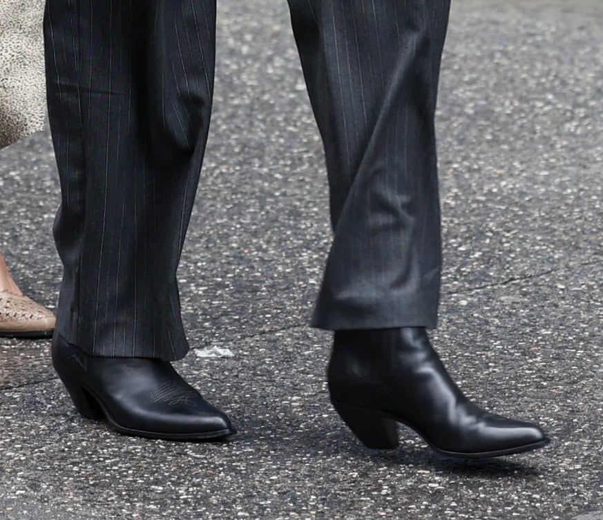 Anne Hathaway adds a bold element to her lady boss suit with black Golden Goose western-style ankle boots