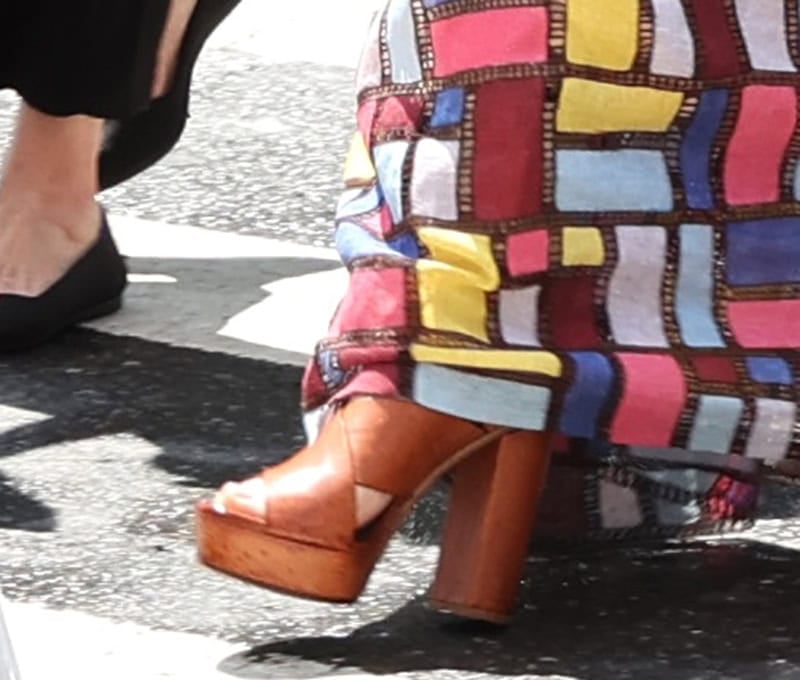 Anne Hathaway goes retro-boho-chic in brown Chloe platform sandals featuring thick crisscross straps, platforms, and high block heels