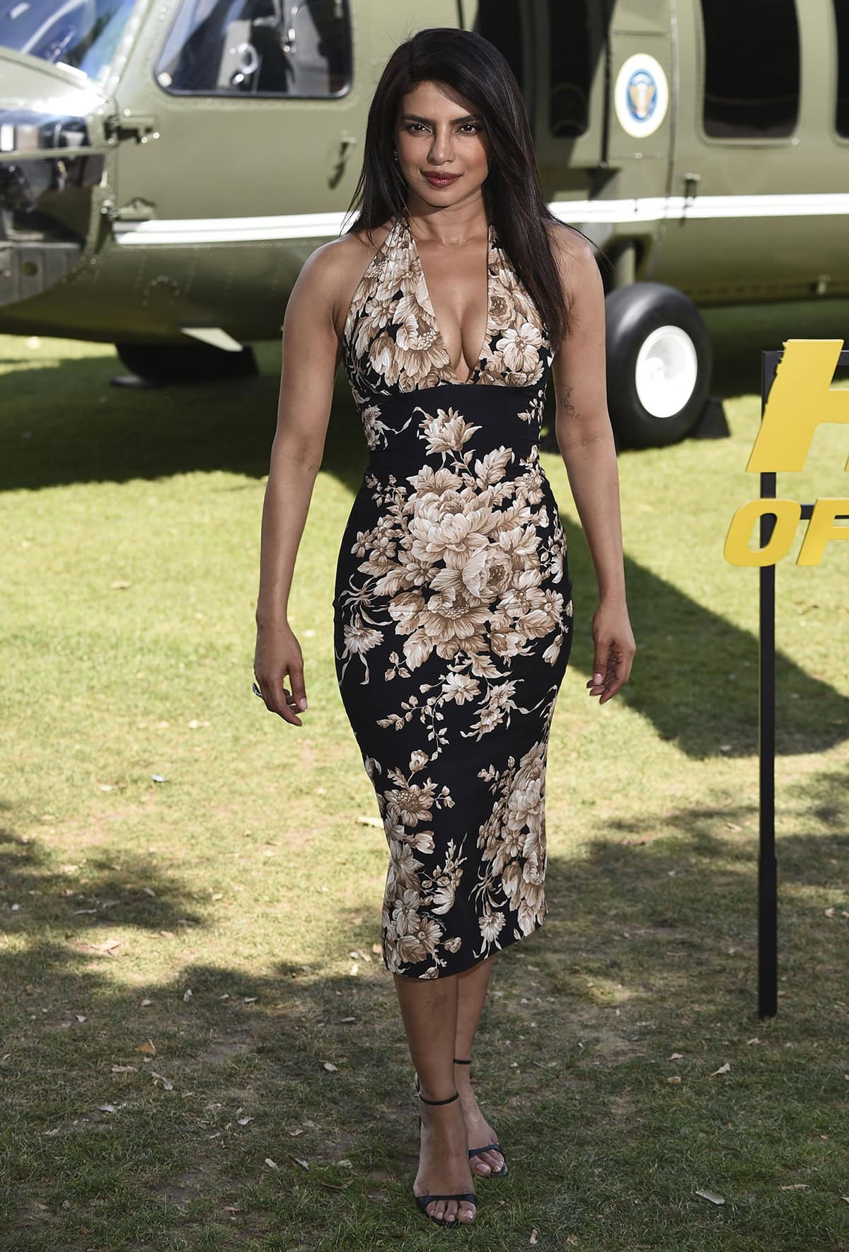 Priyanka Chopra showcases her signature feminine style in a floral halter dress by Dolce Gabbana at the Heads of State London photocall at Potters Fields Park