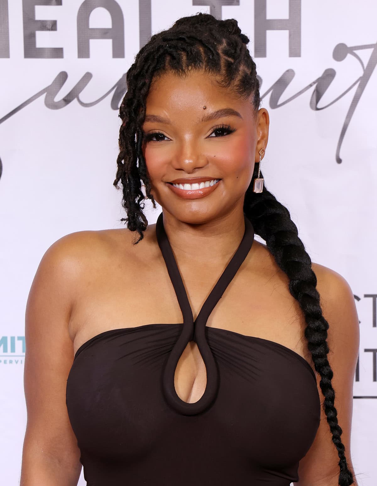 Halle Bailey styles her long tresses in braids with a side part and wears a neutral makeup palette to highlight her natural beauty