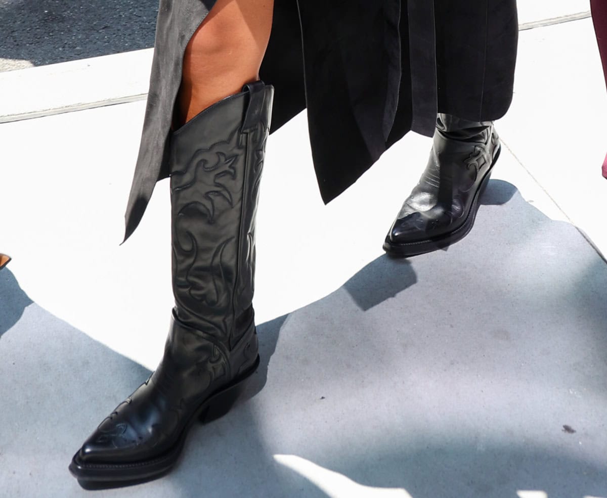 Jessica Alba adds drama to her sleek ensemble with the Gabriela Hearst Capitana cowboy boots featuring flame-inspired western embroideries, snipped toes, and short block heels