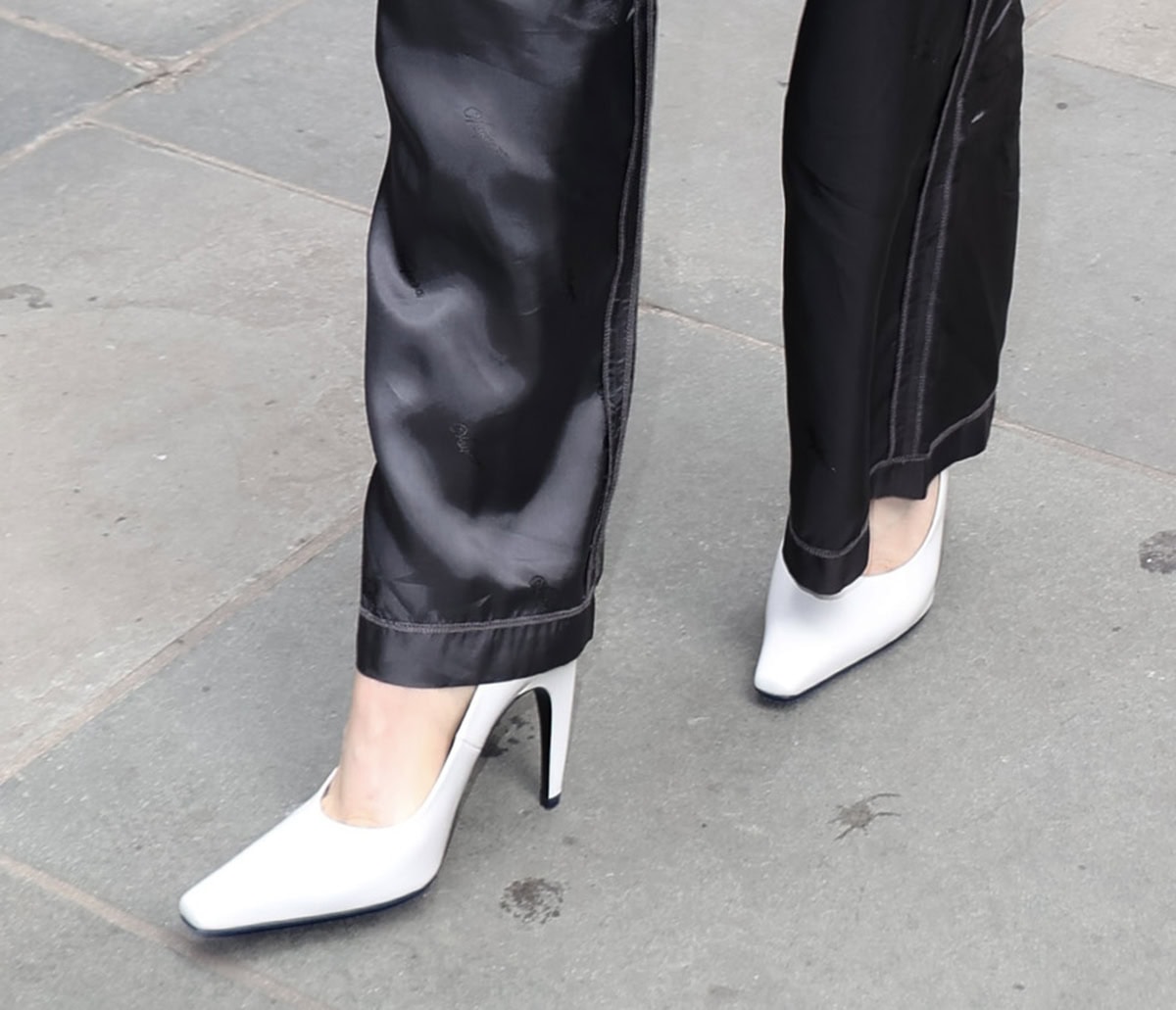 Chloë Grace Moretz pairs her monochromatic ensemble with the popular Jude "Fame" pumps in brushed white leather, creating a sharp, modern contrast
