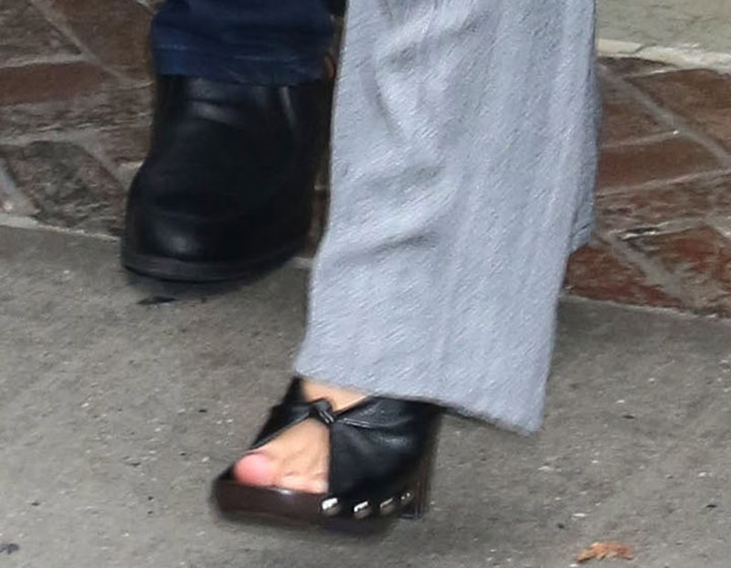 Margot Robbie completes her modern monochromatic business look with chunky wooden clogs by Phoebe Philo