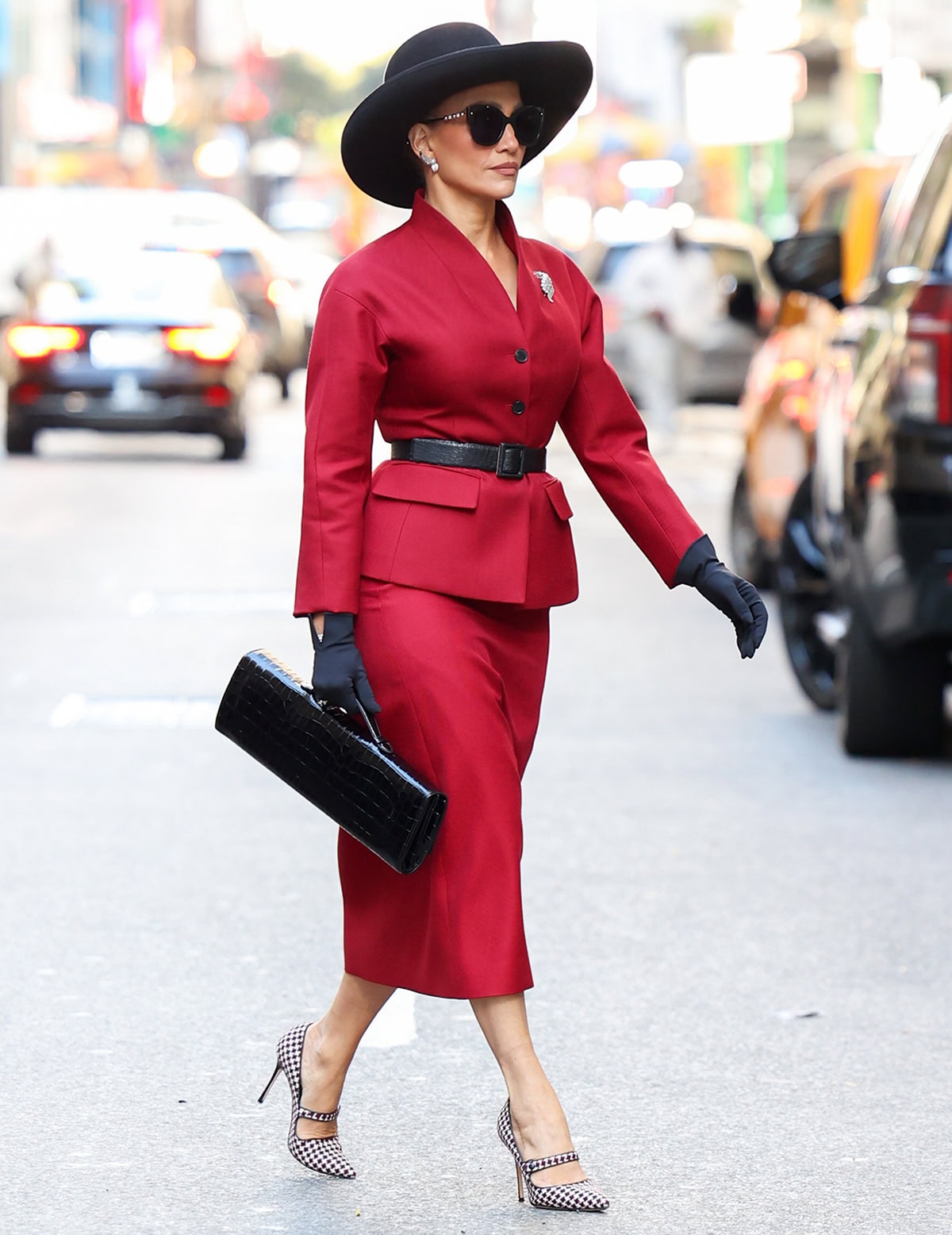 Jennifer Lopez on the set of her upcoming film, The Last Mrs. Parrish, looking striking and powerful in a red Dior skirt suit and Manolo Blahnik pumps