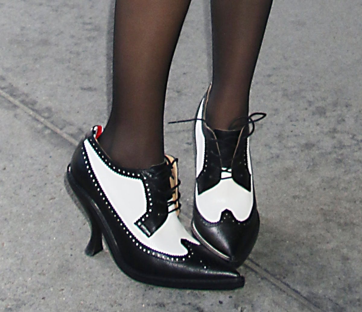 A close-up of McKenna’s black-and-white Thom Browne spectator brogues reveals the curved heels, wingtip detailing, and signature grosgrain tab