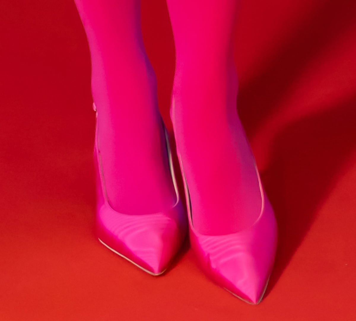 Rita Ora proves Barbiecore is still thriving as she wears hot pink tights with matching hot pink Russell Bromley "Hillcliffe" slingback pumps