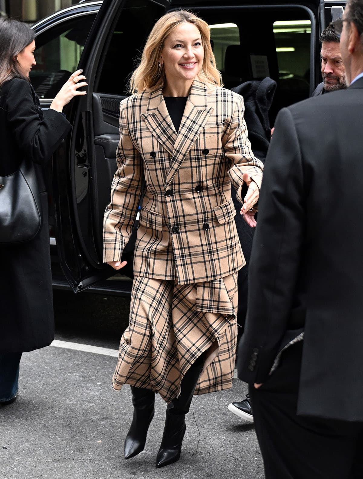 Kate Hudson looks cozy in her oversized camel-and-brown check-print jacket and matching midi skirt with an asymmetrical hem from Ami Paris at the QA screening of Song Sung Blue at the Robin Williams Center–SAG-AFTRA Foundation