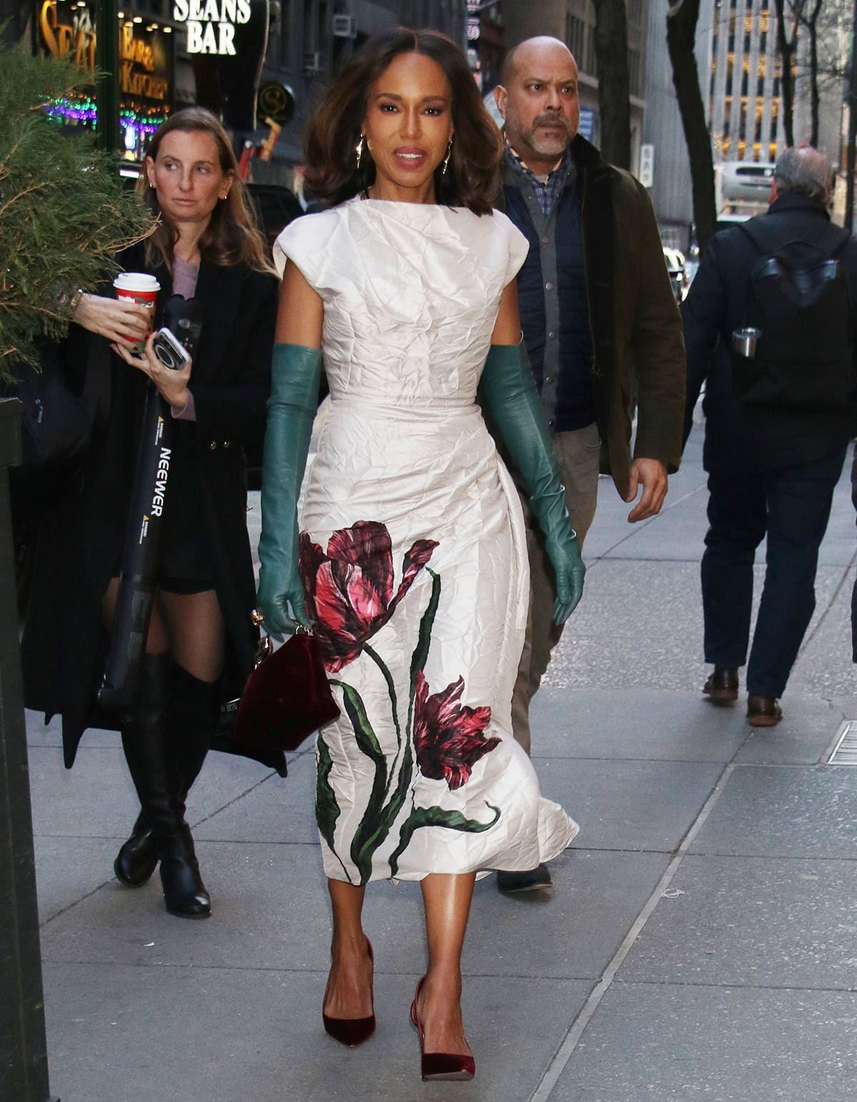 Kerry Washington arrives at the Today show in New York City on December 9, 2025, pairing a white floral Erdem dress with teal opera gloves and burgundy velvet Aquazzura pumps while promoting Wake Up Dead Man: A Knives Out Mystery