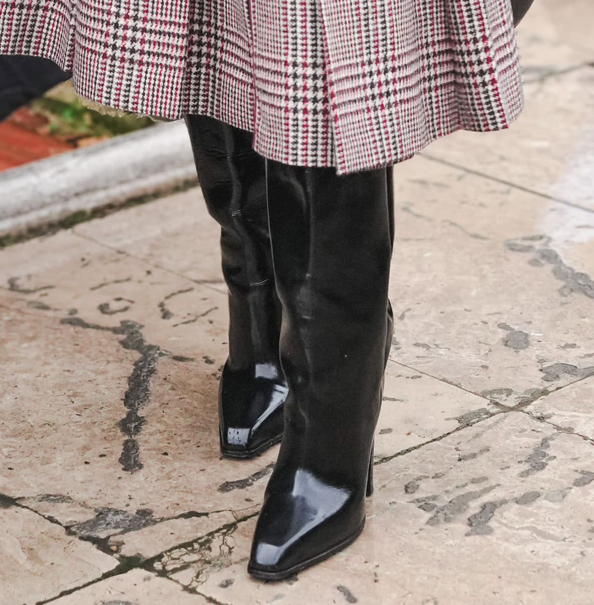 Joy Sunday opts for a chic but more practical pair of boots featuring a snipped toe, slouchy shaft, and block heels